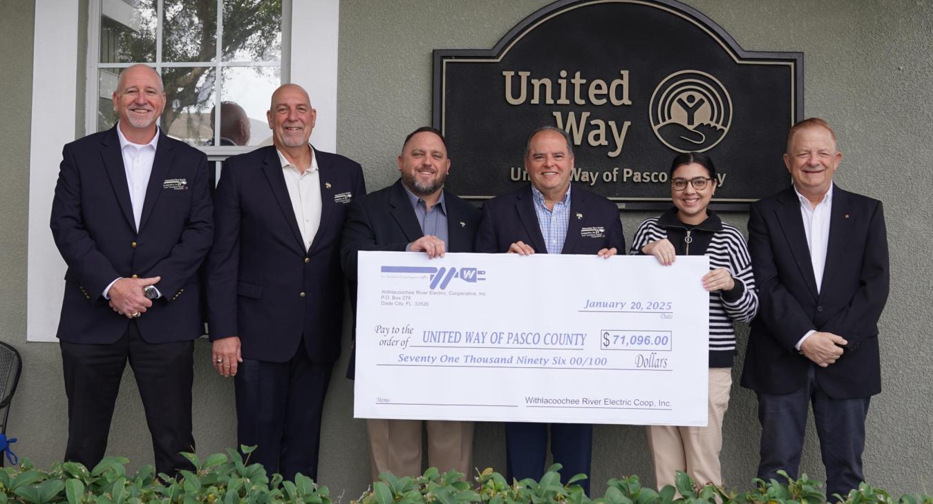 WREC presents United Way of Pasco County with a $71,096.00 donation check