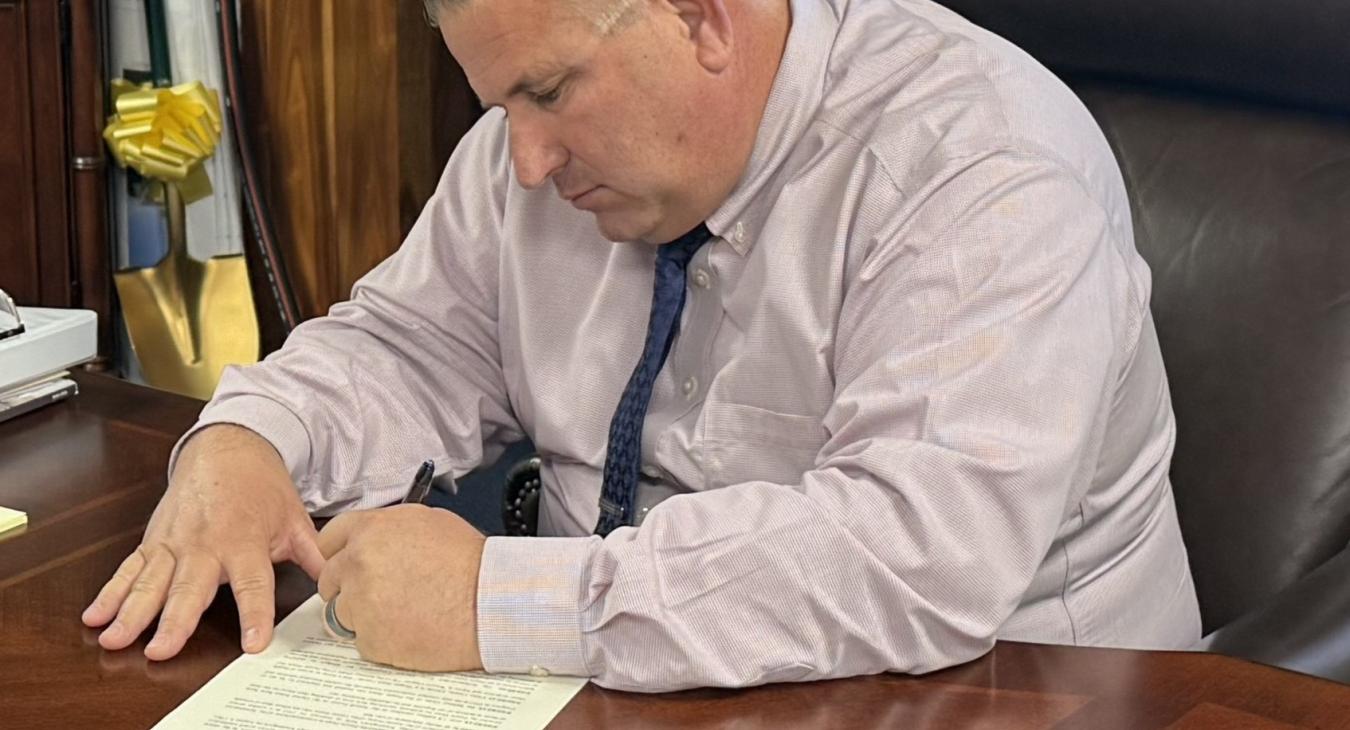 WREC's General Manager Signs Official Proclamation